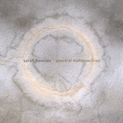 Album cover for Sarah Hennies' Spectral Malsconcities featuring a close-up photograph of a textured white surface with a dark, circular pattern in the center.